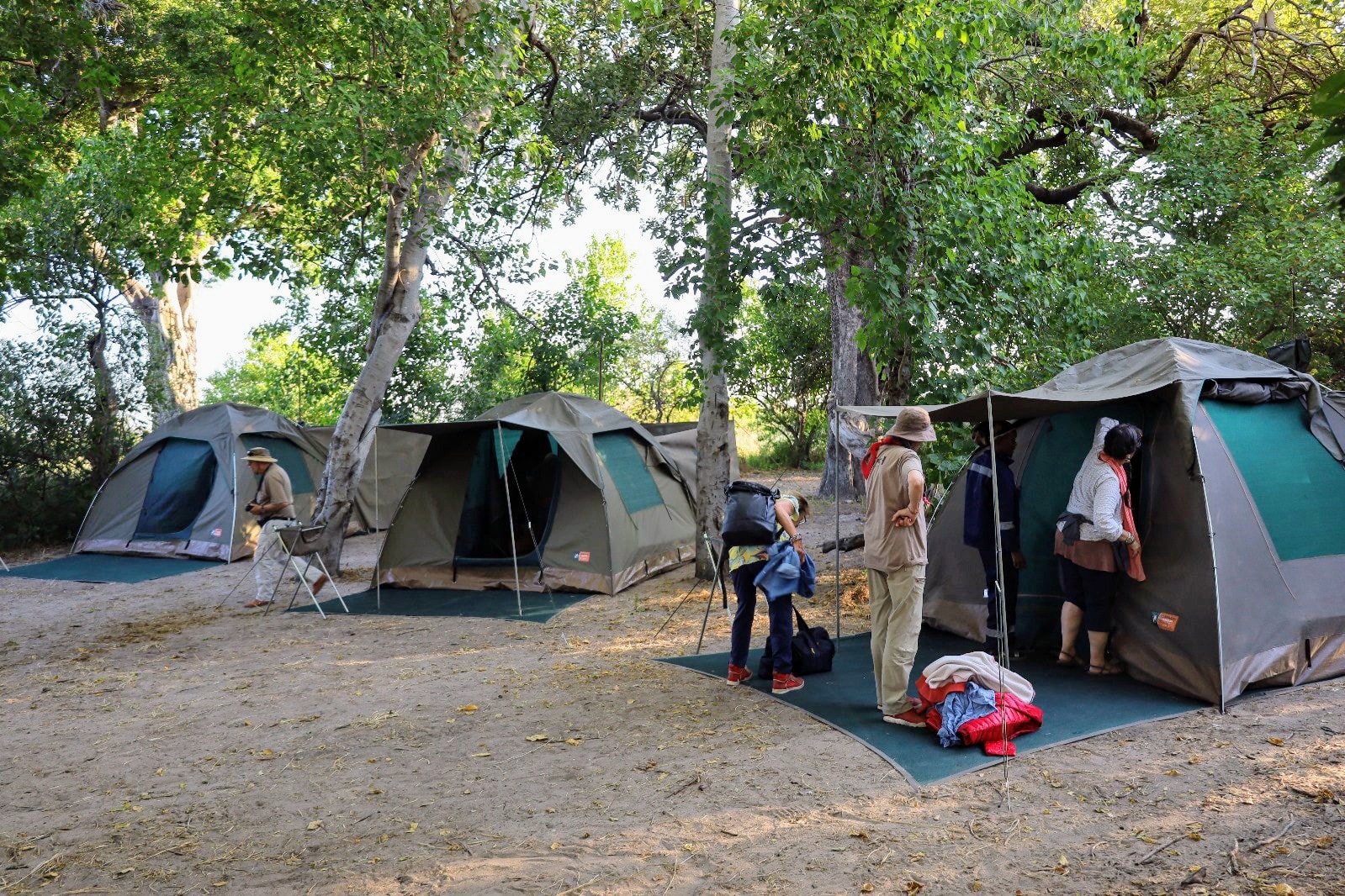 Mobile safari camp with fire at dusk in the African wilderness